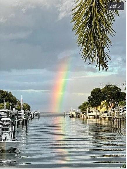 A view of a canal with boats docked on both sides and a rainbow overhead — 2001 HAWAII AVENUE NE, ST PETERSBURG, FL