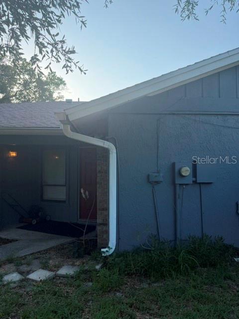 The exterior of a blue house features a white downspout and a covered entryway — 4604 FERN PINE DRIVE, ORLANDO, FL