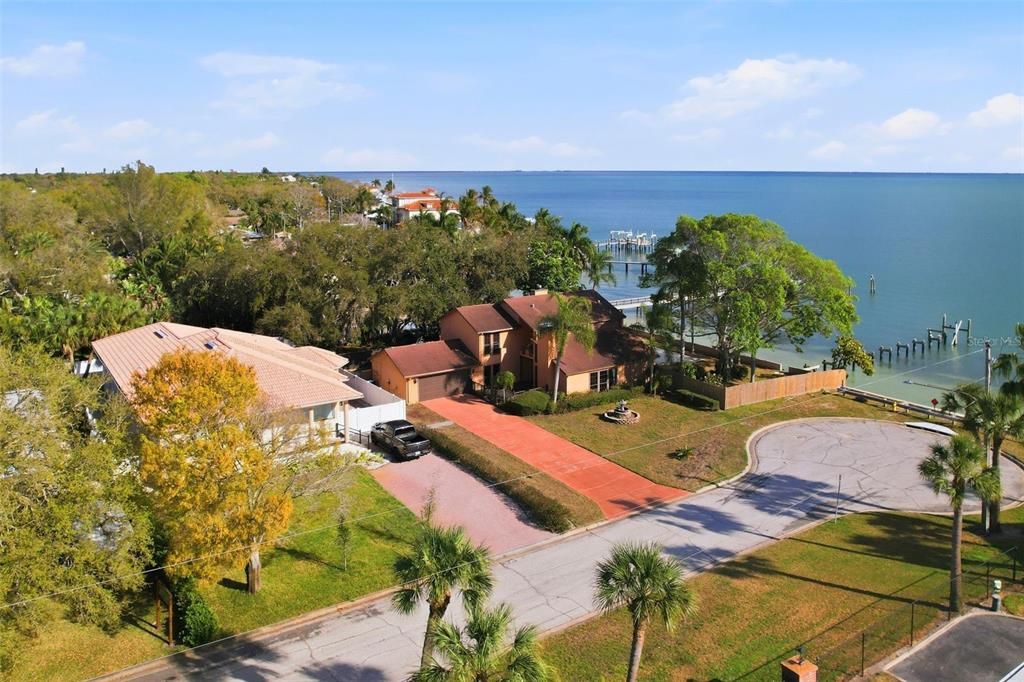 An aerial view shows two houses with driveways near a waterfront with a private dock — 6754 31ST STREET S, ST PETERSBURG, FL