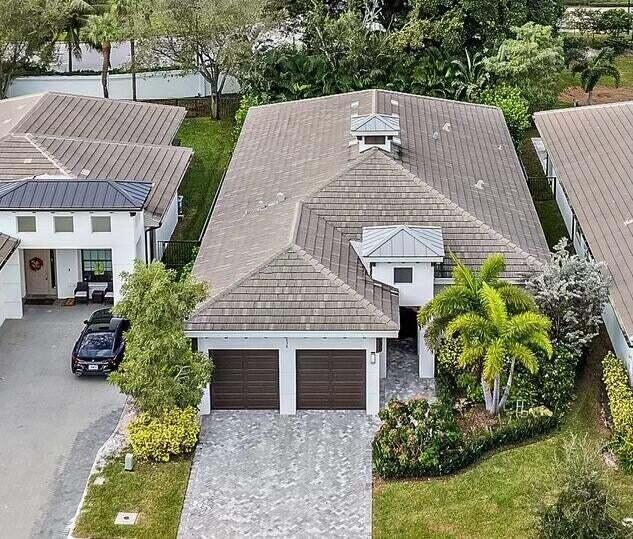 An aerial view of a single-story house with a tiled roof and a two-car garage — 2938 Gin Berry Way, West Palm Beach FL 33401, WEST PALM BEACH, FL