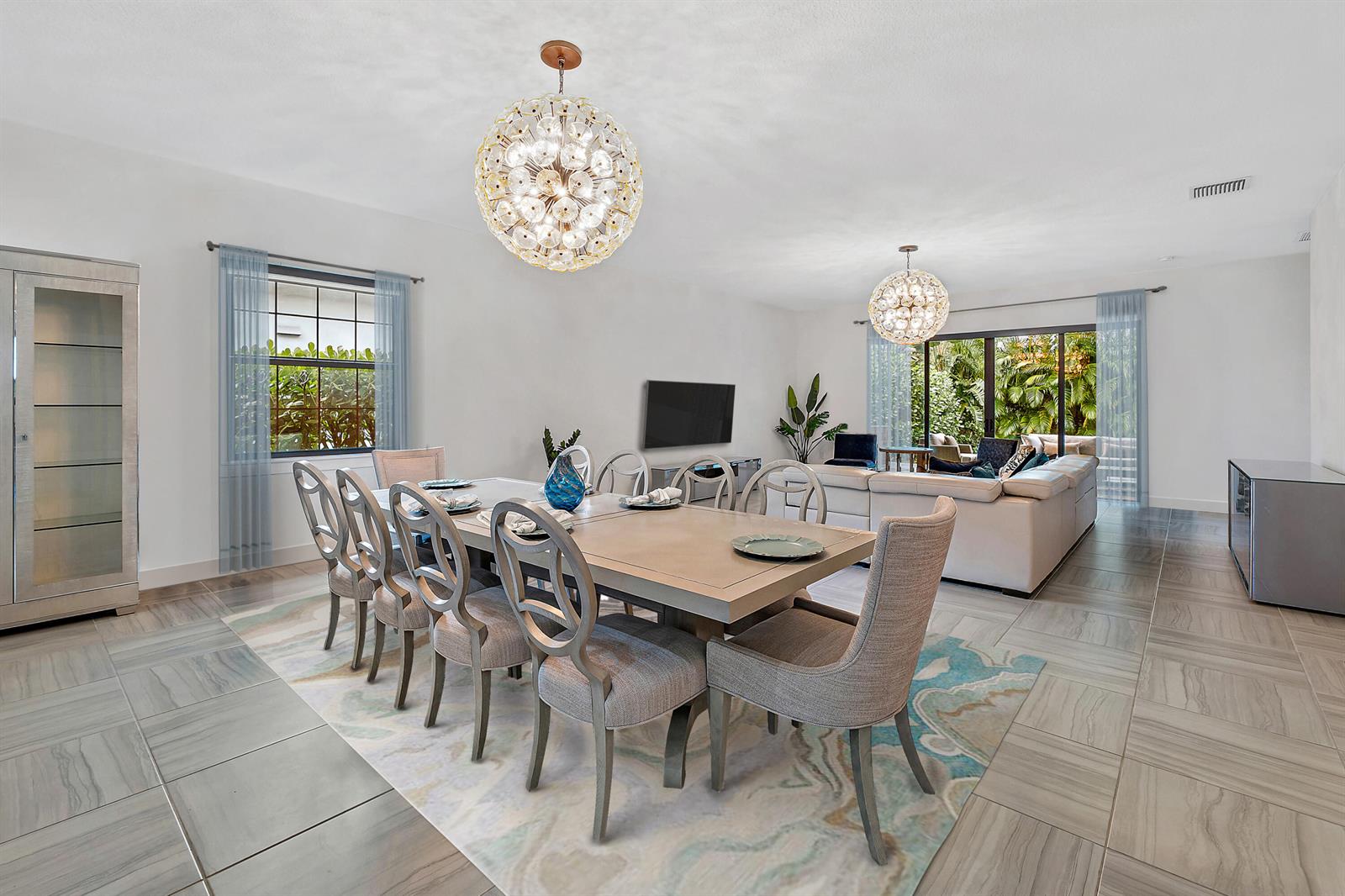 A dining area with a large table and chairs sits in front of a living room — 2938 Gin Berry Way, West Palm Beach FL 33401, WEST PALM BEACH, FL
