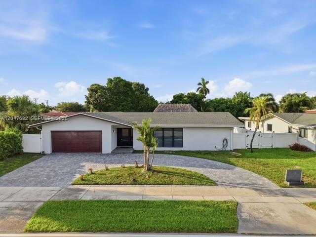 A single-story house with a white exterior, a brown garage door, and a paved driveway — BOCA RATON, FL