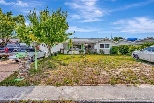 A single-story house with a stone mailbox and two cars parked in the driveway — 10825 BRIDLETON ROAD, PORT RICHEY, FL