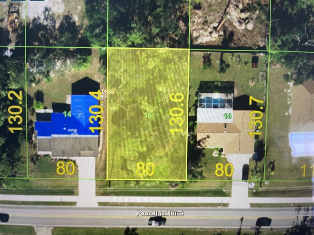 This is a map showing a vacant residential lot highlighted in yellow between two houses — 21086 PEACHLAND BOULEVARD, PORT CHARLOTTE, FL