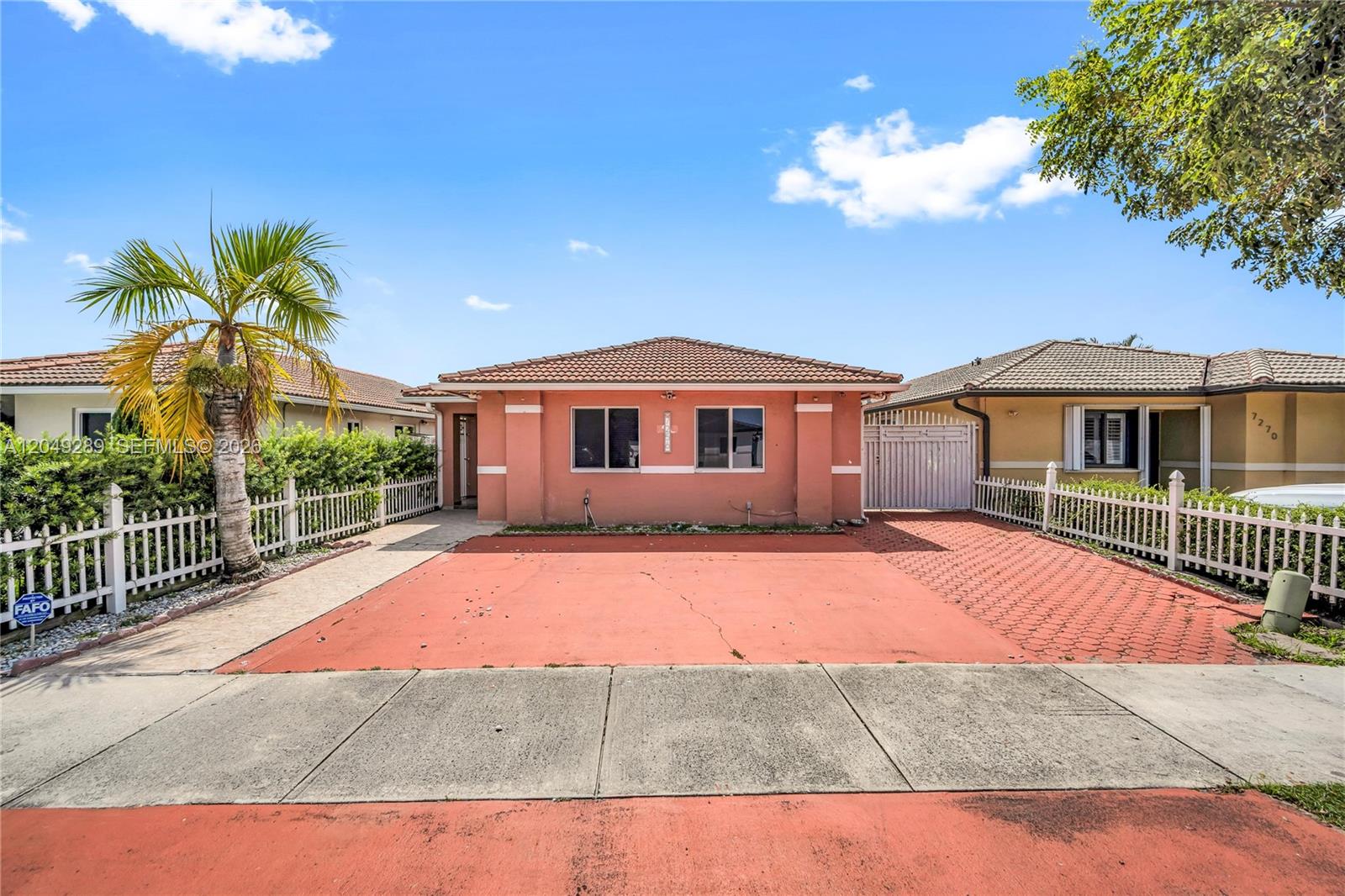 A single-story peach-colored house with a tiled roof and a paved driveway — 7256 W 34th Ln, Hialeah FL 33018, HIALEAH, FL