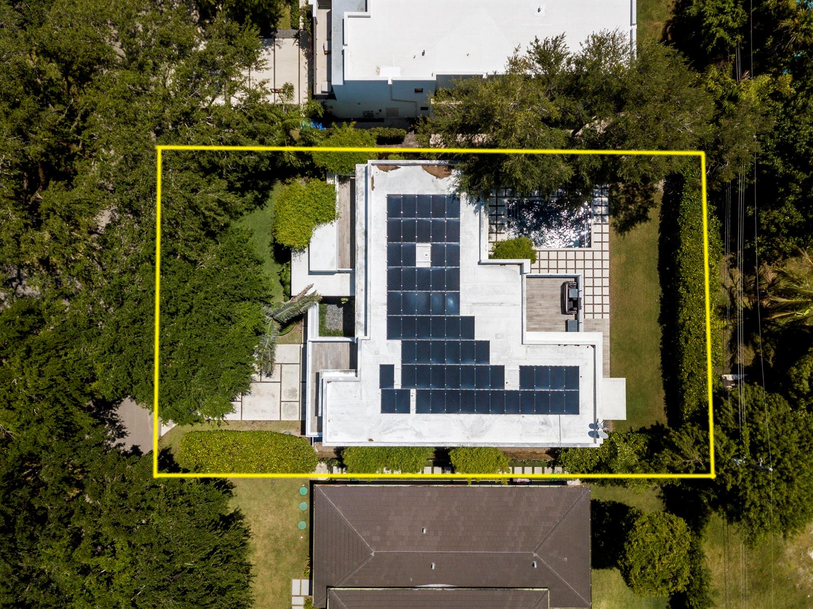 An aerial view shows a modern flat-roofed house with solar panels and a backyard pool — 7700 SW 53rd Court, Miami FL 33143, MIAMI, FL