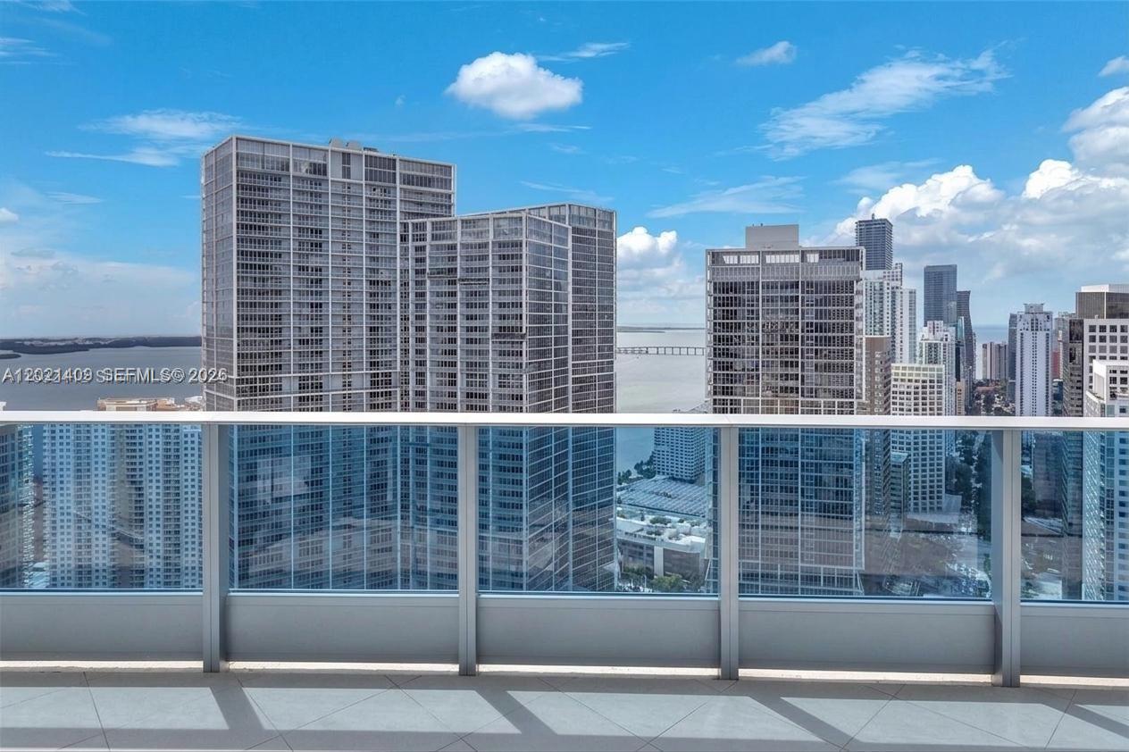 An aerial view of a waterfront city skyline featuring numerous high-rise residential towers — 200 Biscayne Boulevard Way # 5004, Miami FL 33131, MIAMI, FL