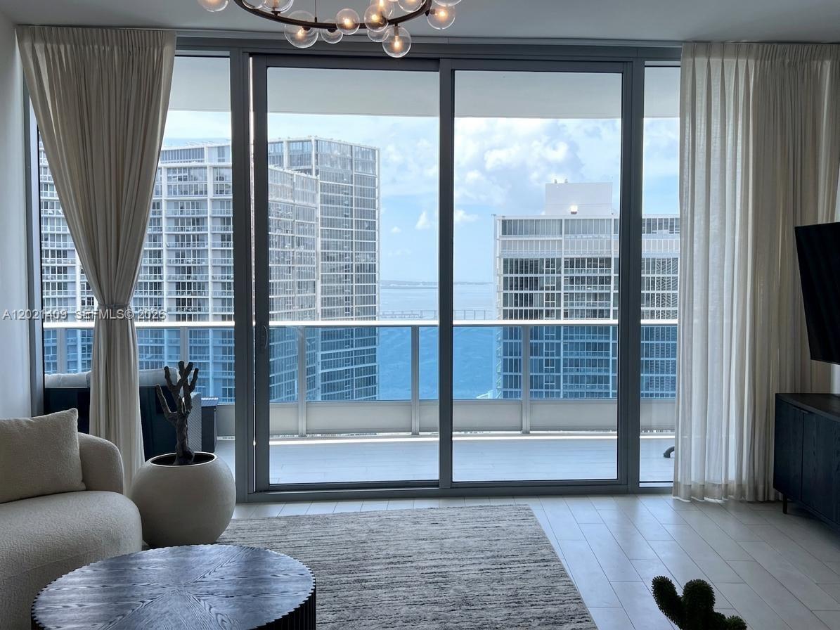 An aerial view of a city street lined with tall glass skyscrapers and palm trees — 200 Biscayne Boulevard Way # 5004, Miami FL 33131, MIAMI, FL