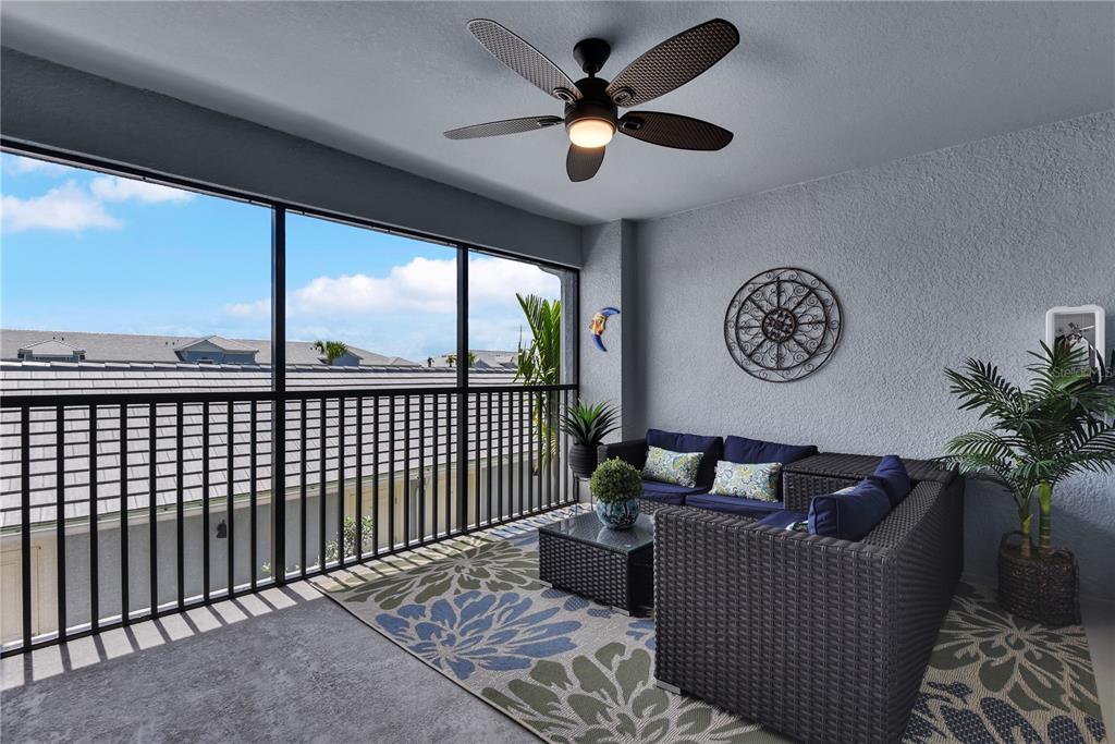 A covered balcony features a wicker sectional, a patterned rug, and a ceiling fan — 14271 HERITAGE LANDING BOULEVARD UNIT 1527, PUNTA GORDA, FL