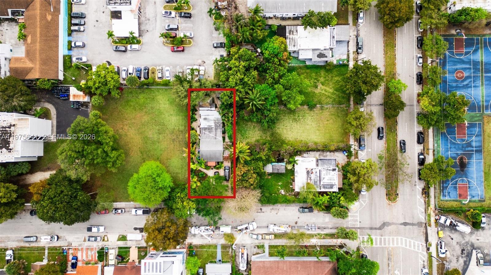 An aerial view shows a rectangular property with a house surrounded by trees and grass — 410 NW 31st St, Miami FL 33127, MIAMI, FL