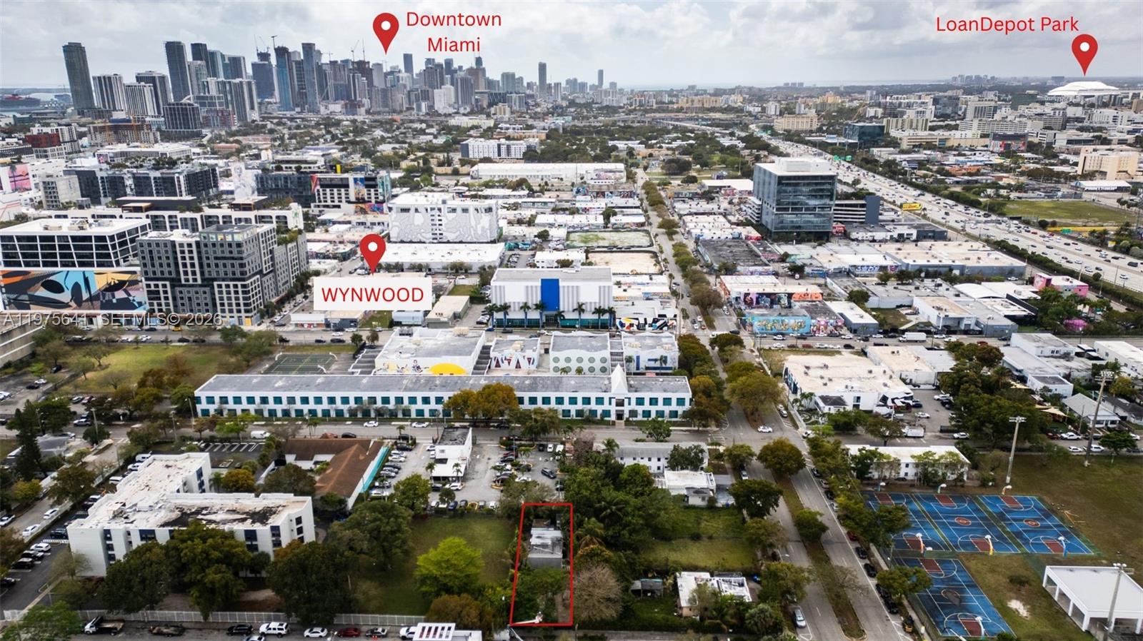 This aerial view shows a small house outlined in red near a public basketball court — 410 NW 31st St, Miami FL 33127, MIAMI, FL