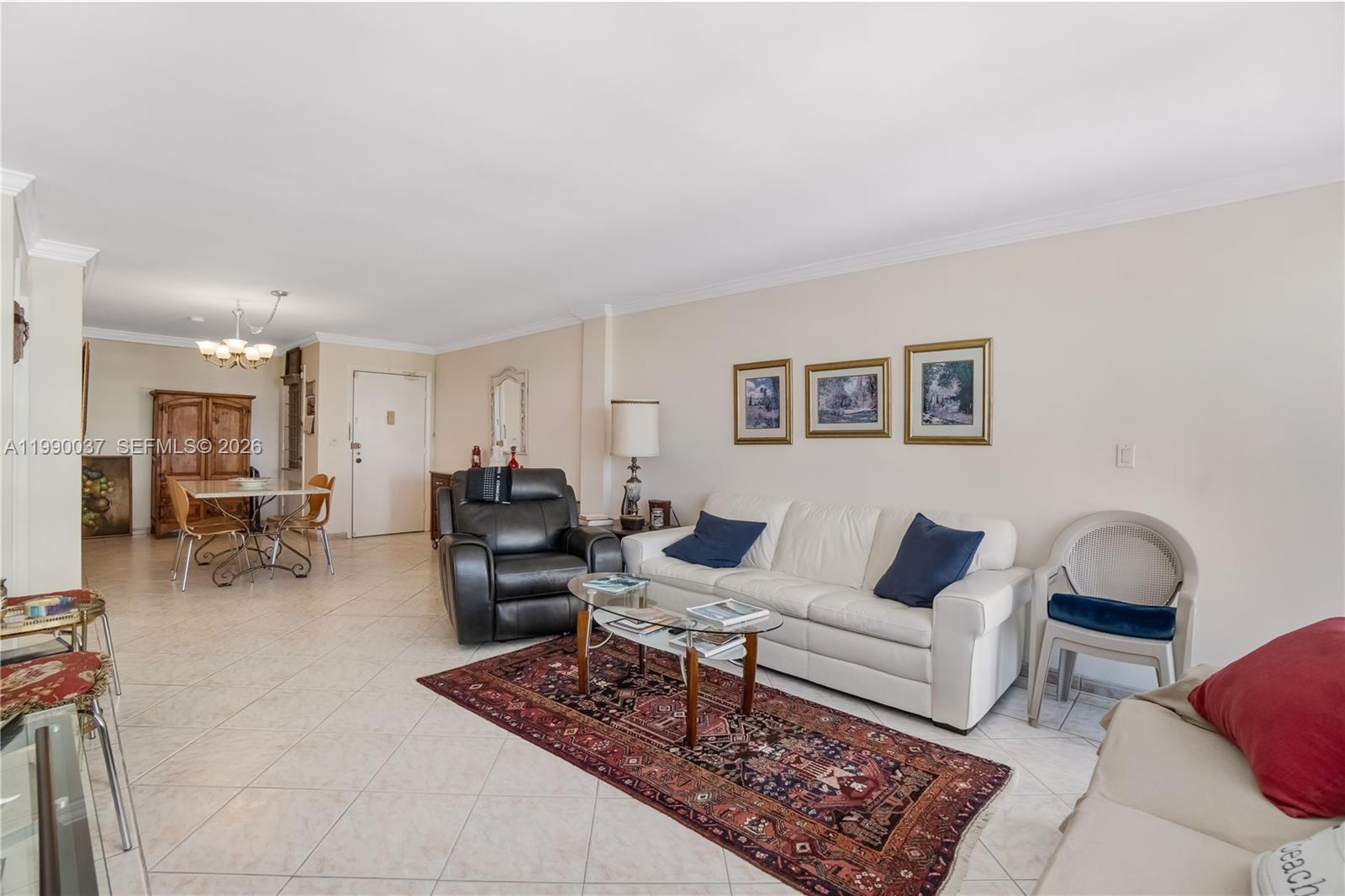 A living room features a white sofa, a black recliner, and a dining area nearby — 245 18th St # 904, Miami Beach FL 33139, MIAMI BEACH, FL