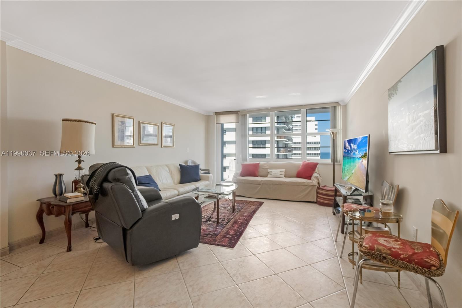 A living room features tile flooring, a leather recliner, two sofas, and a television — 245 18th St # 904, Miami Beach FL 33139, MIAMI BEACH, FL