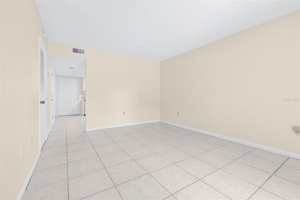 An empty room with light-colored tile flooring and beige walls — 2944 MORGAN COMBEE ROAD, LAKELAND, FL