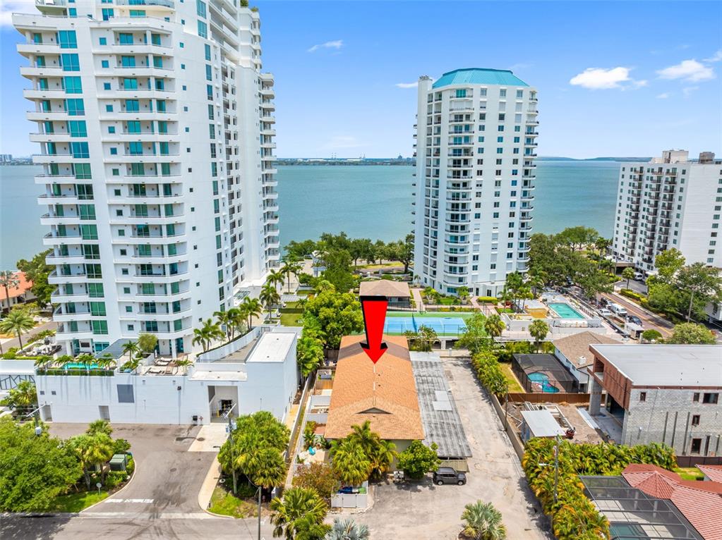 An aerial view shows a low-rise building with a brown roof surrounded by high-rise towers — 3420 S CARTER STREET UNIT C, TAMPA, FL