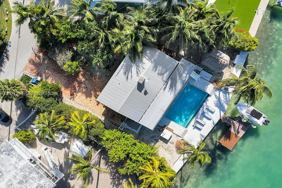 An aerial view shows a house with a metal roof, swimming pool, and private dock — 166 Bayview Drive, Islamorada FL 33036, ISLAMORADA, FL