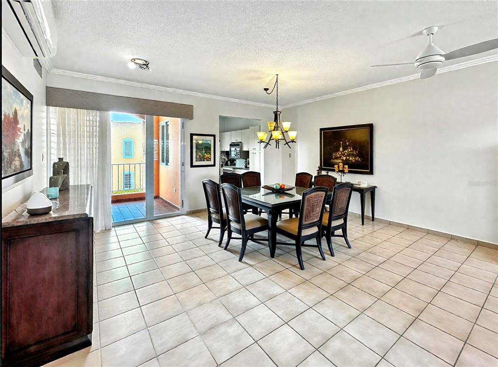 A dining room with tile floors, a glass-top table, and a balcony view — Candelero Drive SE FAIRWAY COURTS - PALMAS DEL MAR COURTS N UNIT 734, HUMACAO, PR