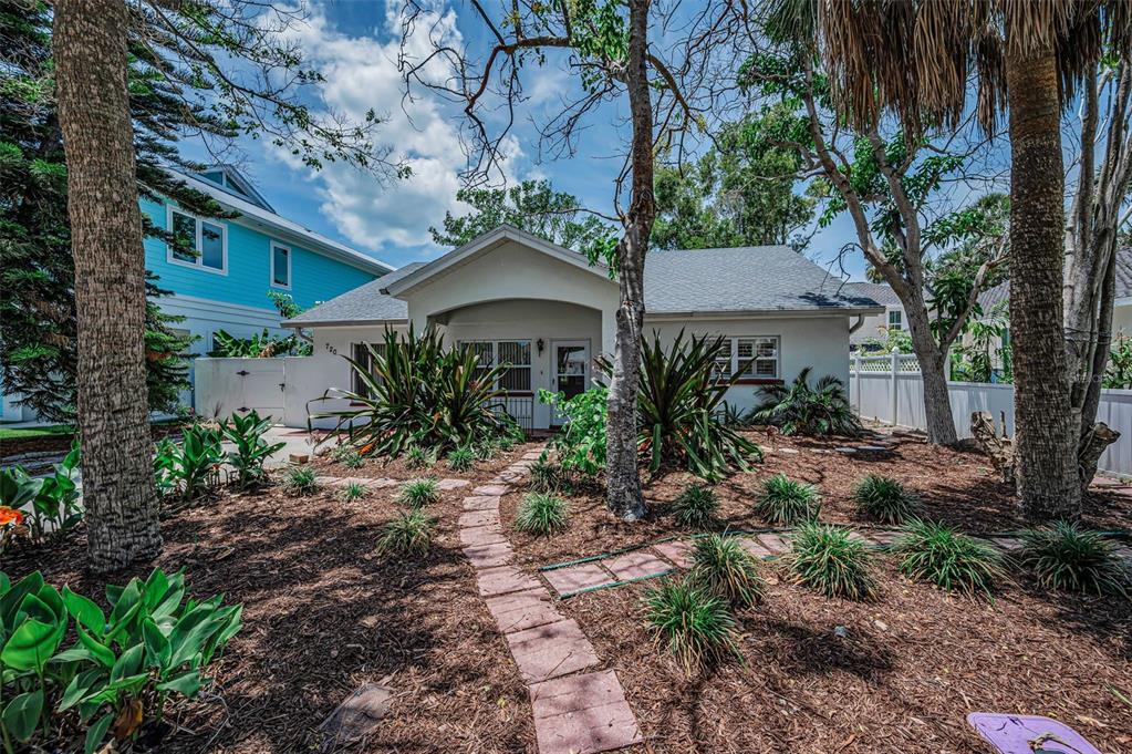 A single-story house with a stone walkway leading to the front entrance and landscaped yard — 720 BRUCE AVENUE, CLEARWATER BEACH, FL