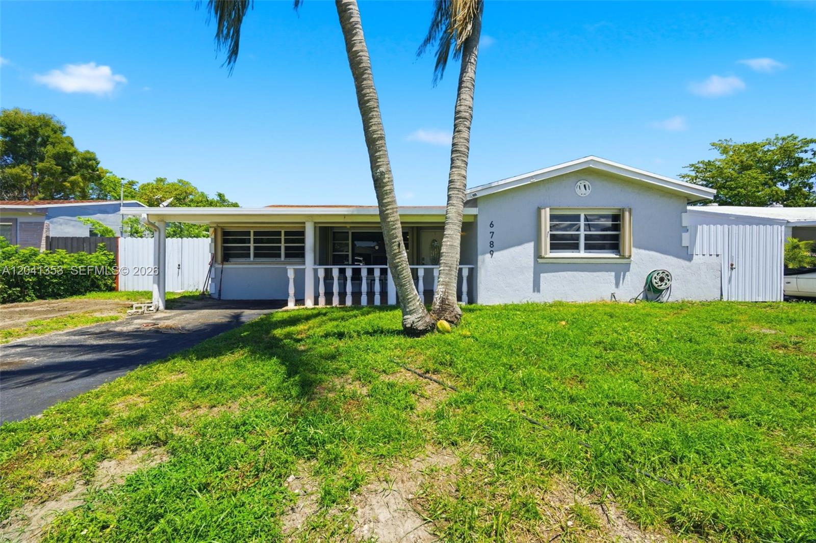 A single-story house with a covered porch, palm trees, and a grassy front yard — 6789 SW 27th Ct, Miramar FL 33023, MIRAMAR, FL