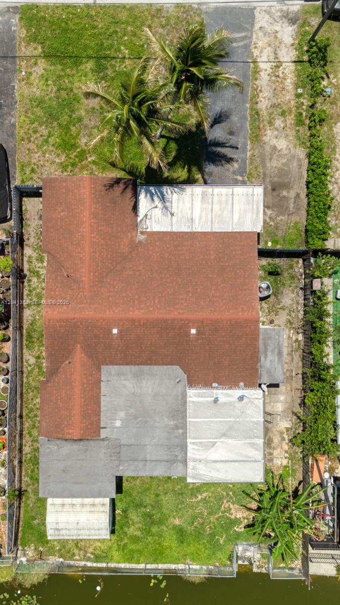 An aerial view shows a house with a brown shingled roof and several flat-roofed additions — 6789 SW 27th Ct, Miramar FL 33023, MIRAMAR, FL