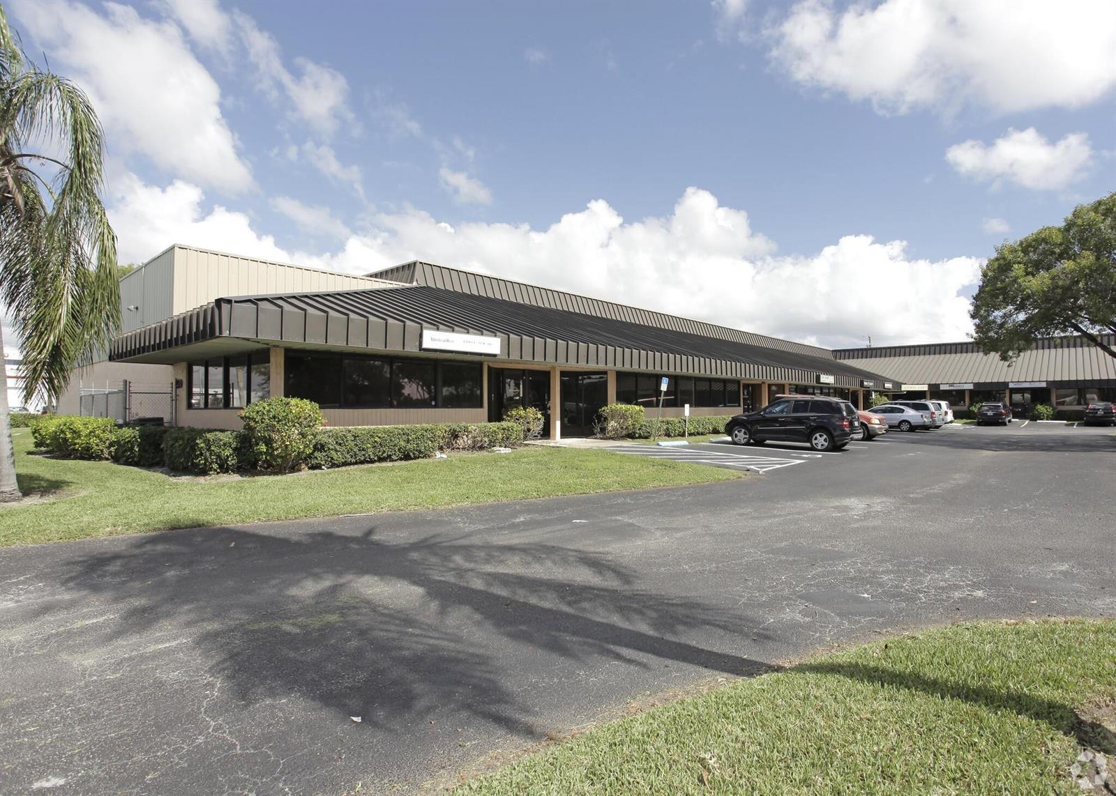 A single-story commercial office building with a dark metal awning and an asphalt parking lot — 290 SW 12th Avenue, Pompano Beach FL 33069, POMPANO BEACH, FL