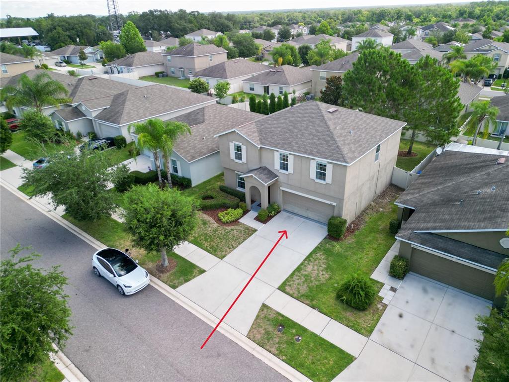 An aerial view shows a two-story suburban house with a driveway and attached garage — 3621 KEARSNEY ABBEY CIRCLE, DOVER, FL