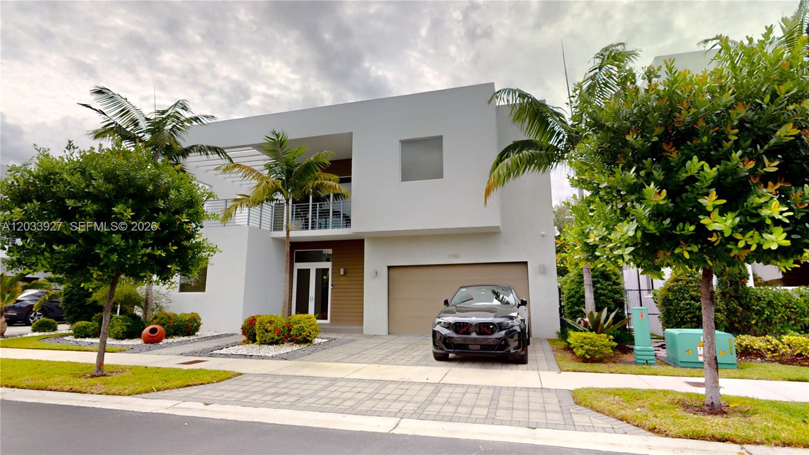 A modern two-story house with a paved driveway, a black car, and palm trees — 9980 NW 74th Ter # 9980, Doral FL 33178, DORAL, FL