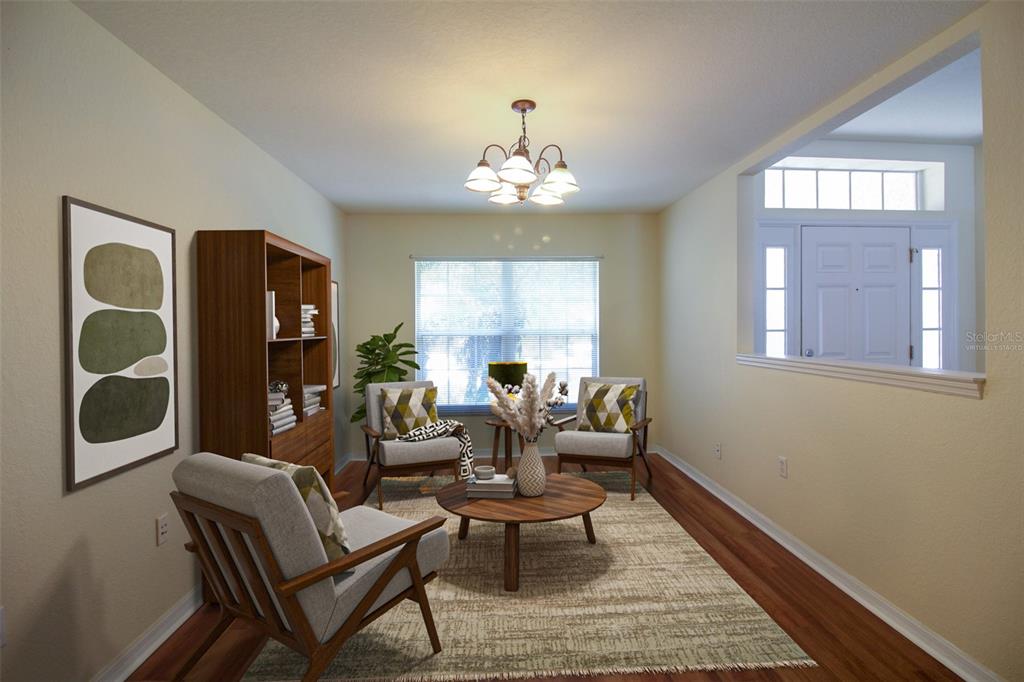 A living room features three armchairs, a wooden coffee table, a bookshelf, and hardwood floors — 6719 HIGHLANDS CREEK BOULEVARD, LAKELAND, FL