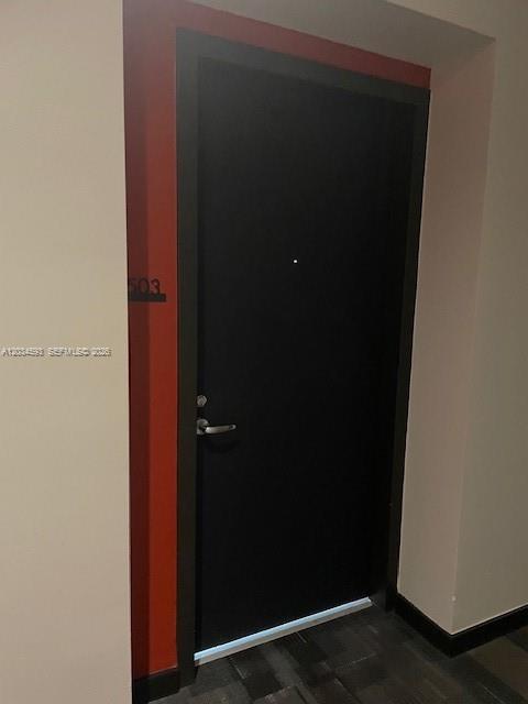A black apartment door with the number 503 is set against a red wall — 151 SE 1ST # 1503, Miami FL 33131, MIAMI, FL