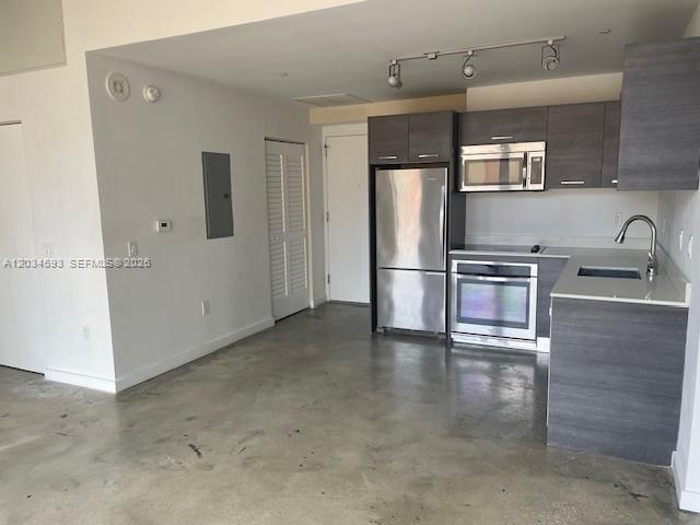 A kitchen with stainless steel appliances, dark wood cabinets, and polished concrete floors — 151 SE 1ST # 1503, Miami FL 33131, MIAMI, FL