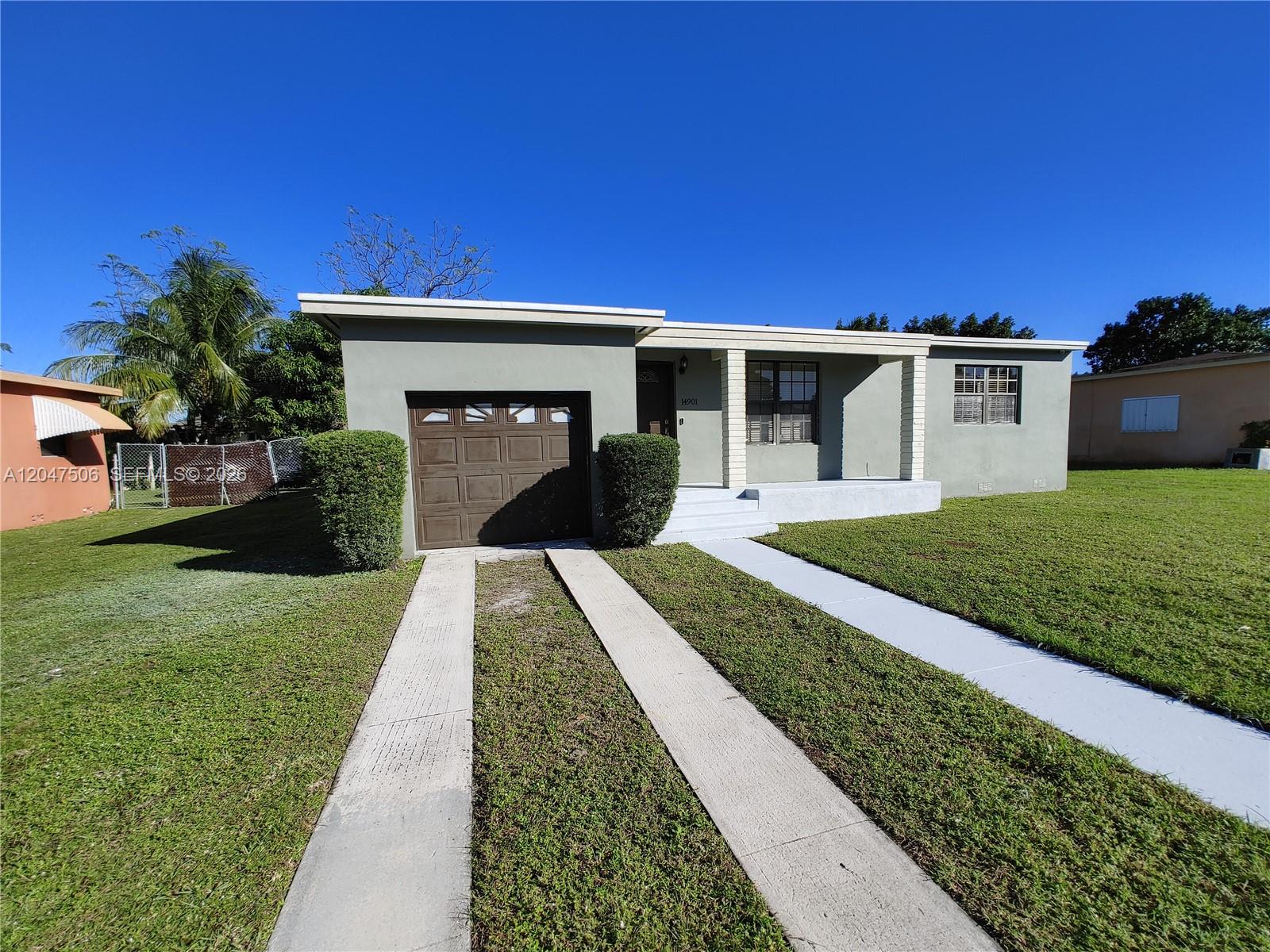 A single-story house with a garage, a concrete driveway, and a front porch — 14901 NW 9th Ct # 14901, Miami FL 33168, MIAMI, FL