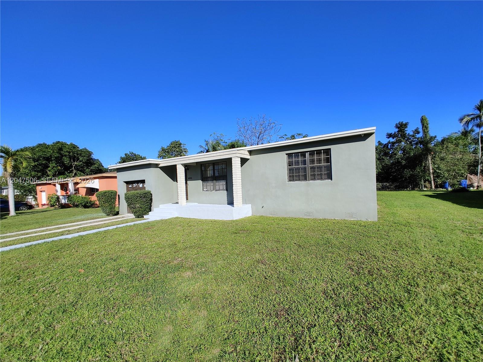 A single-story gray house with a flat roof, front porch, and large lawn — 14901 NW 9th Ct # 14901, Miami FL 33168, MIAMI, FL