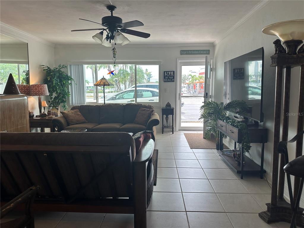 A living room with tile floors, a ceiling fan, a sofa, and a television — 6161 GULF WINDS DRIVE UNIT 150, ST PETE BEACH, FL