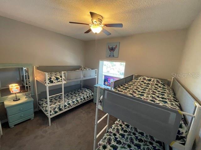 A bedroom features two bunk beds, a light blue nightstand, and a ceiling fan — 3143 SUN LAKE COURT UNIT B, KISSIMMEE, FL