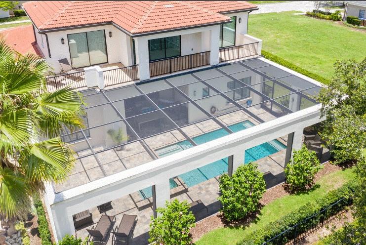 An aerial view of a house with a screened-in pool and patio area — 1253 RADIANT STREET, REUNION, FL