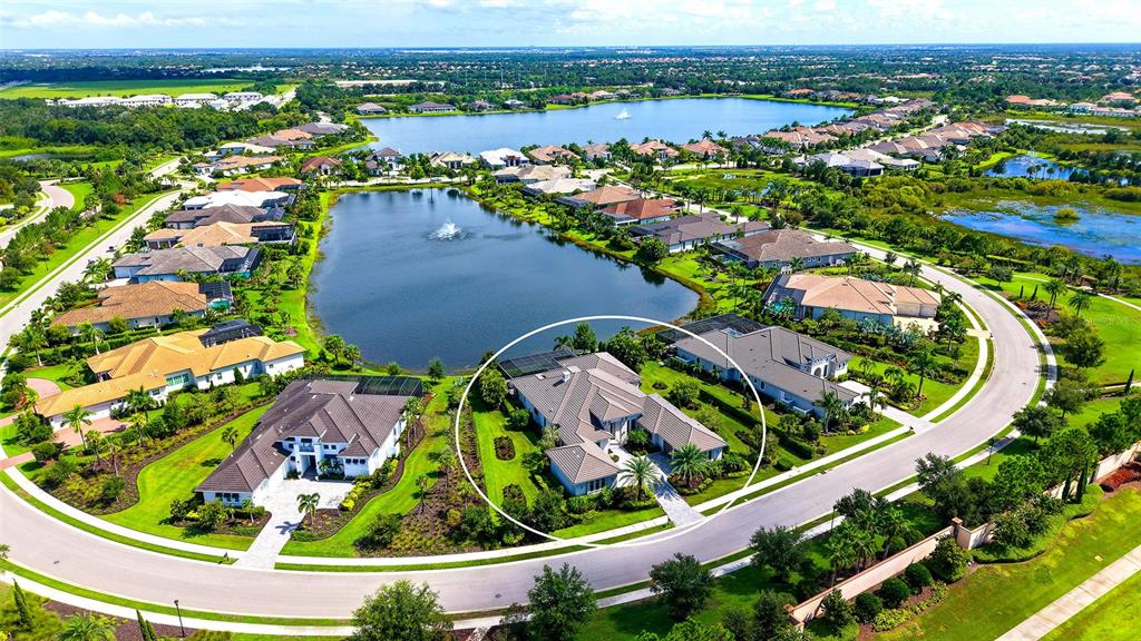 An aerial view shows a residential neighborhood with a large house circled in white — 8339 LUCERNE LOOP, BRADENTON, FL
