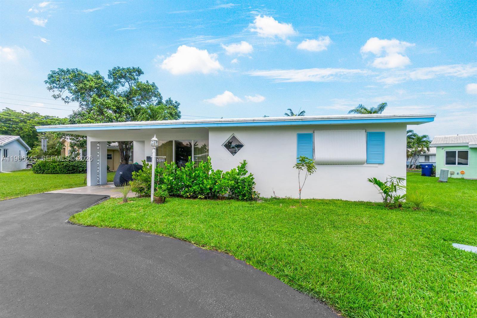 A single-story house with a white exterior, blue shutters, and a covered carport — 3201 Abbott Ln, Hollywood FL 33021, HOLLYWOOD, FL