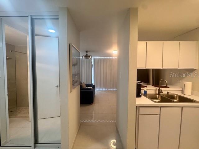 A view from a kitchen looking toward a living area with a bathroom on the left — Ocean Drive 100 UNIT 806, LUQUILLO, PR