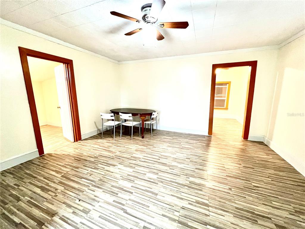 A room with wood-look flooring, a ceiling fan, and a dining table with chairs — 343 WEAVER AVENUE, LAKE WALES, FL