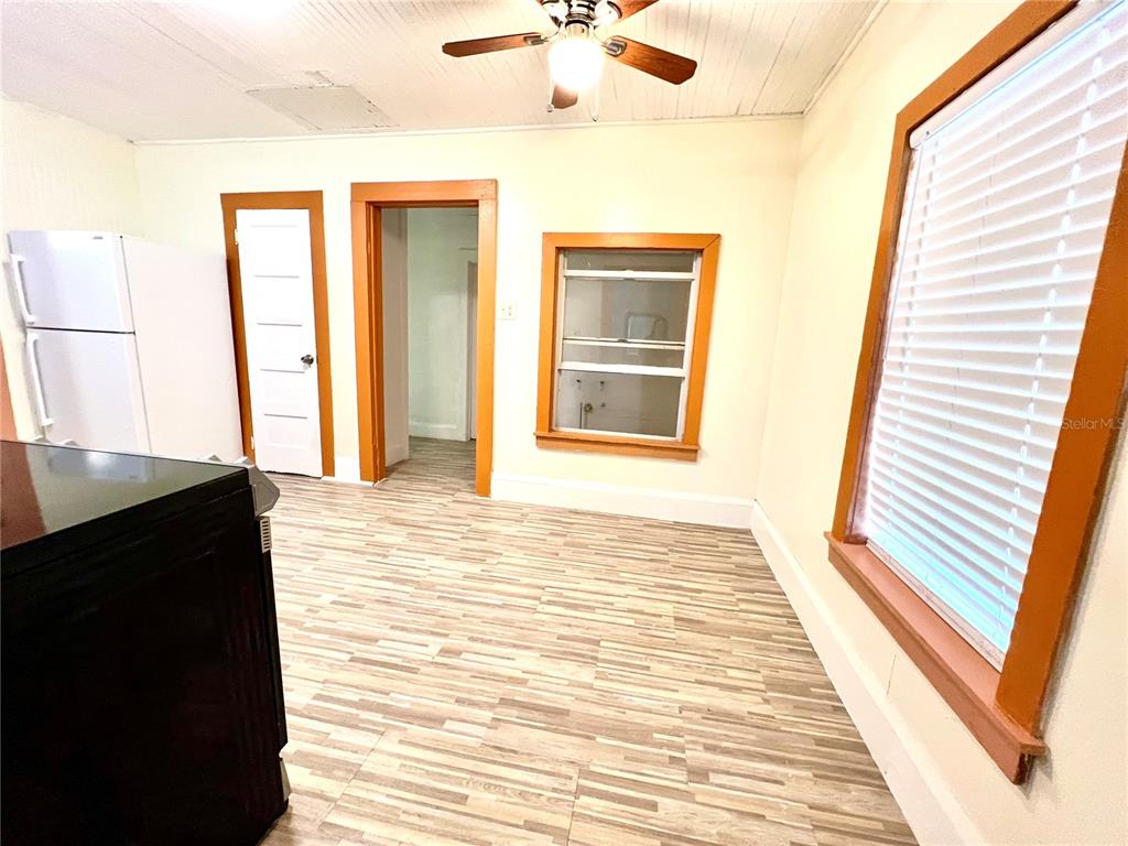 A kitchen with wood-look flooring, a white refrigerator, and a ceiling fan — 343 WEAVER AVENUE, LAKE WALES, FL