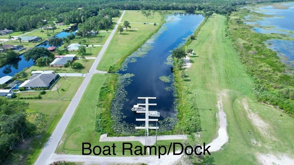 An aerial view shows a boat dock and ramp extending into a narrow canal — 0 LAGUNA DRIVE, INDIAN LAKE ESTATES, FL