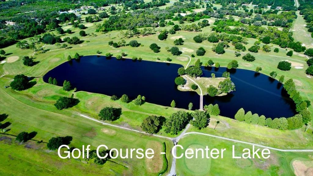 An aerial view shows a large lake surrounded by a green golf course — 0 LAGUNA DRIVE, INDIAN LAKE ESTATES, FL