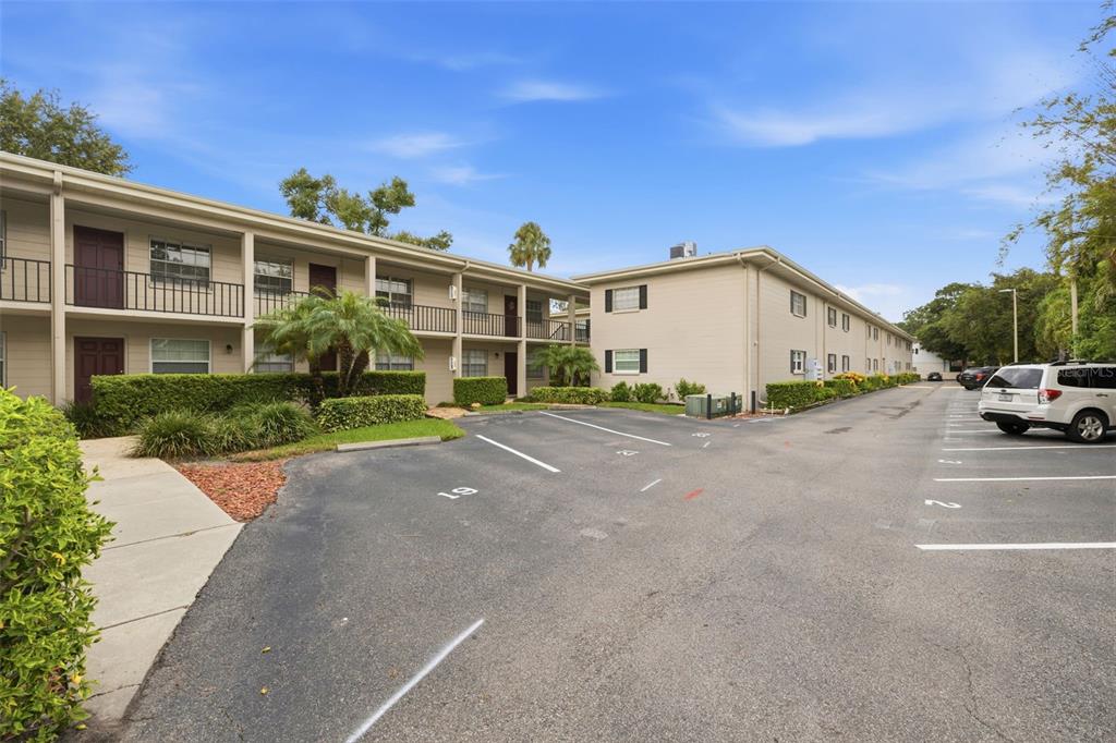 A two-story apartment building with beige siding and a parking lot in the foreground — 2207 S CAROLINA AVENUE UNIT 9, TAMPA, FL