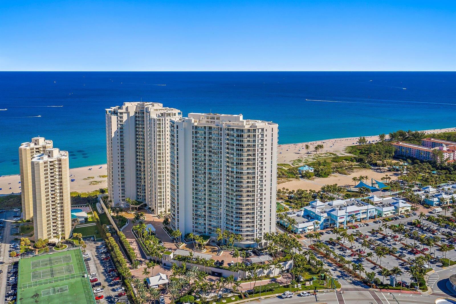 An aerial view of high-rise residential buildings located next to a beach and parking lot — 2700 N Ocean Drive # 1b, Riviera Beach FL 33404, RIVIERA BEACH, FL