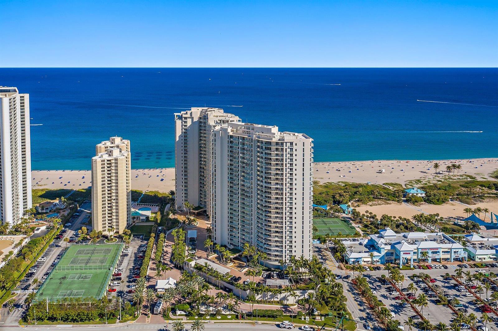 An aerial view of high-rise apartment buildings near a sandy beach and the ocean — 2700 N Ocean Drive # 1b, Riviera Beach FL 33404, RIVIERA BEACH, FL