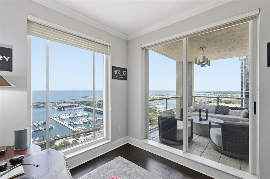 A dining room features a round table, modern chandelier, circular ceiling tray, and herringbone floors — 100 BEACH DRIVE NE UNIT 1900, ST PETERSBURG, FL