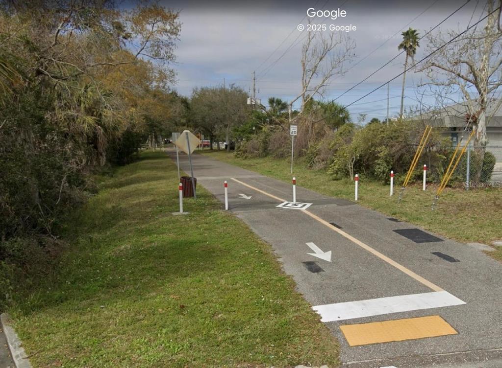 A paved multi-use trail features lane markings, bollards, and a speed limit sign — 1211 HAMLET AVENUE UNIT B, CLEARWATER, FL