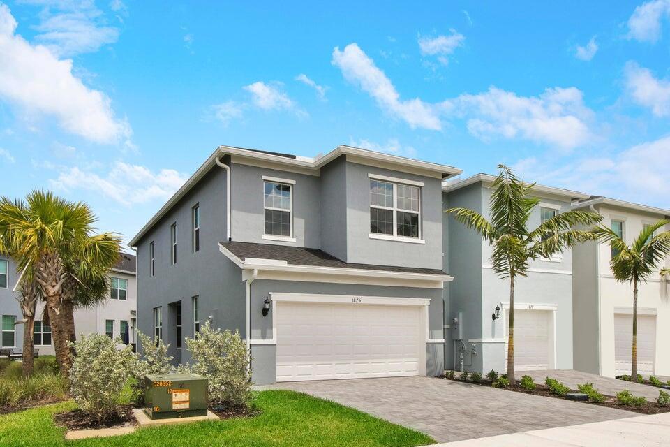 A two-story gray house with a two-car garage and palm trees in the front yard — 1875 SE Ocean Cove Way, Stuart FL 34996, STUART, FL