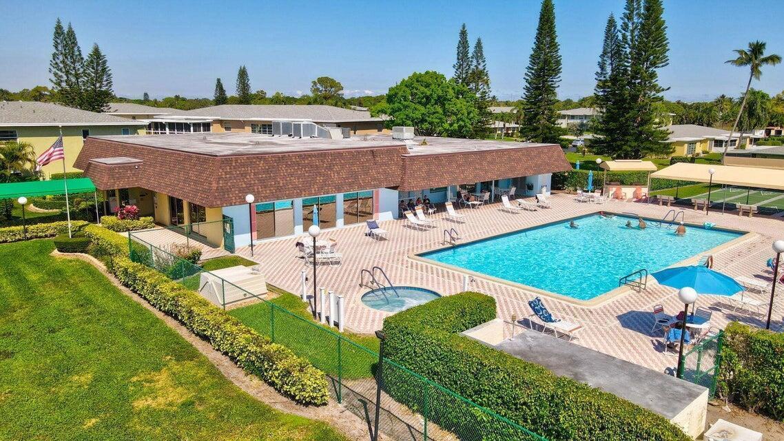 An aerial view of a community swimming pool and hot tub with surrounding patio furniture — 1141 Violet Terrace # 101, Delray Beach FL 33445, DELRAY BEACH, FL
