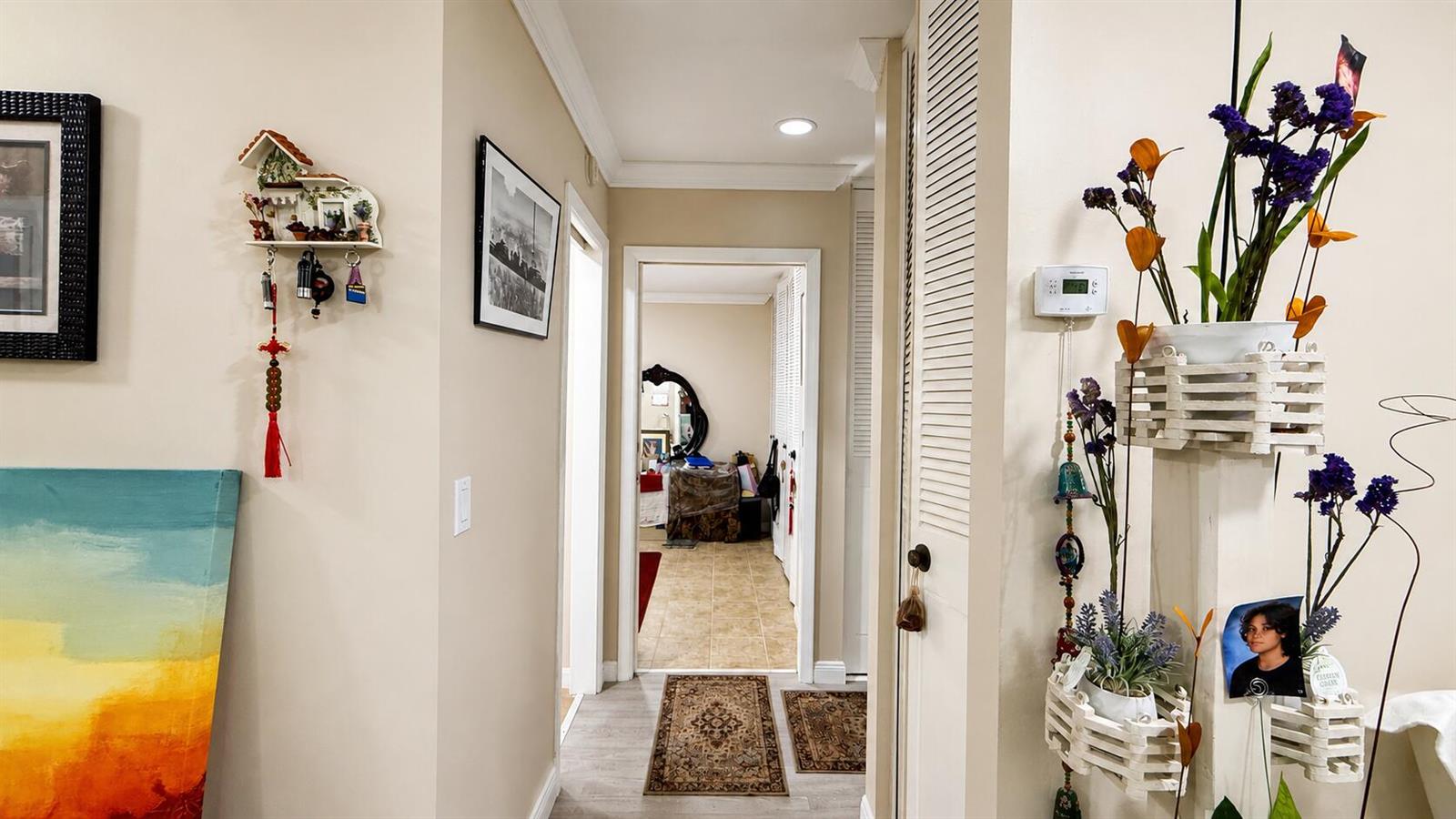 A hallway with light-colored walls leads to a doorway showing a tiled room beyond — 2716 E Emory Dr Drive E # D, West Palm Beach FL 33415, WEST PALM BEACH, FL
